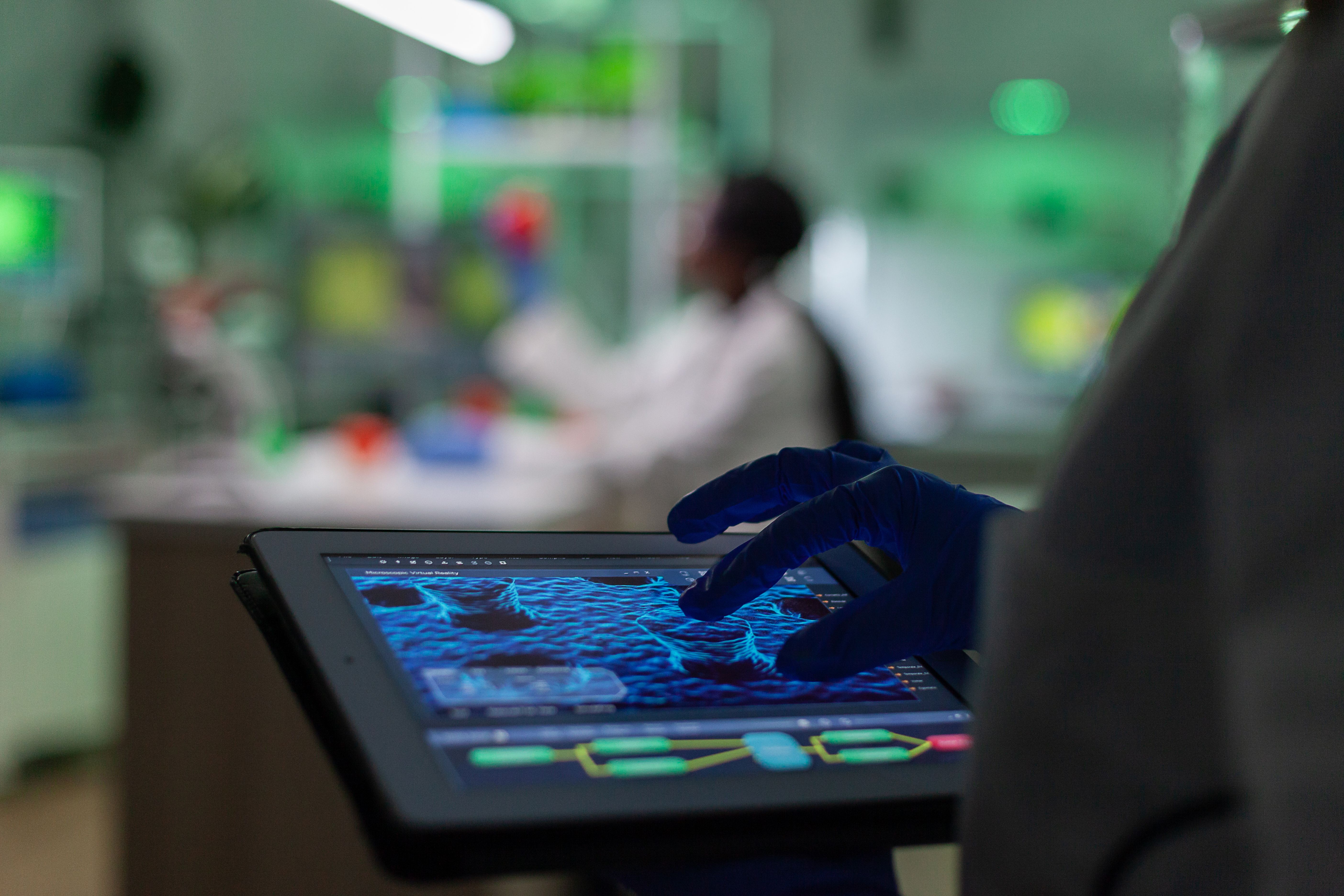 scientist-researcher-doctor-analyzing-genetic-mutation-test-using-tablet-while-her-collegue-typing-biological-expertise-comp.jpg